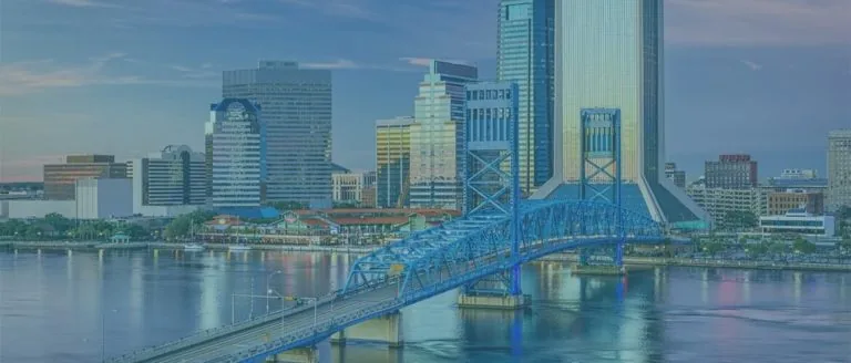 A bridge over a river with cityscape in the background