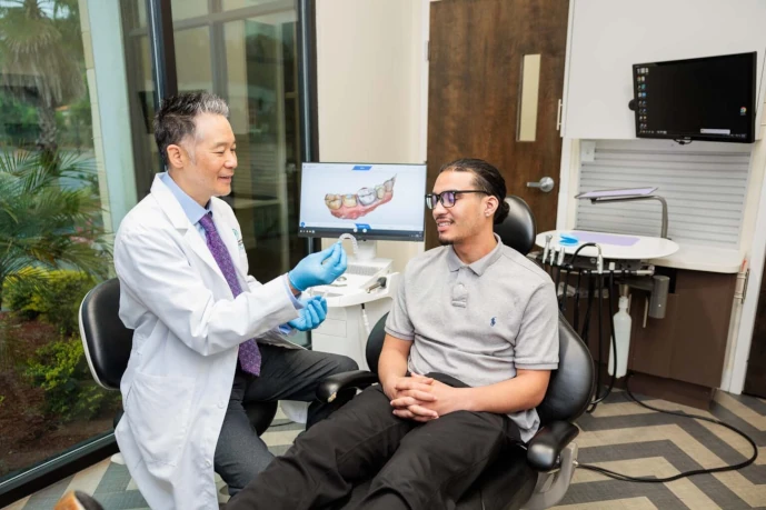 Dr. Lee discussing clear aligners with a patient at Normandy Lake Dentistry in Jacksonville, FL.