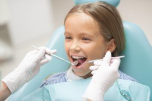 A young girl getting a dental checkup