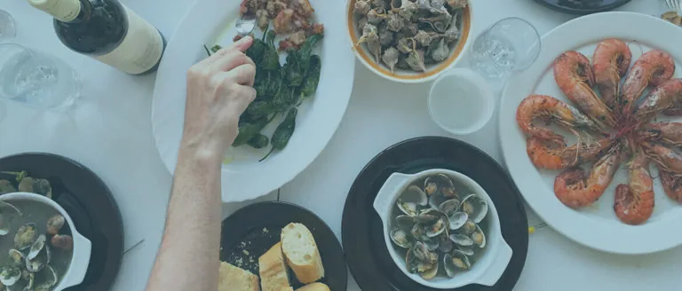 A dining table with plates of food