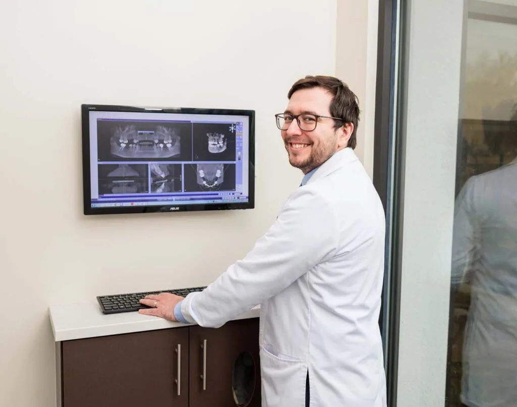 dentist showing teeth xray on monitor